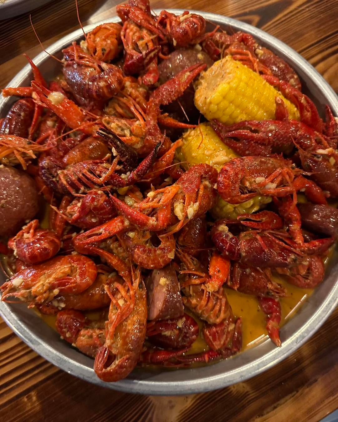 Bowl of boiled crawfish with corn